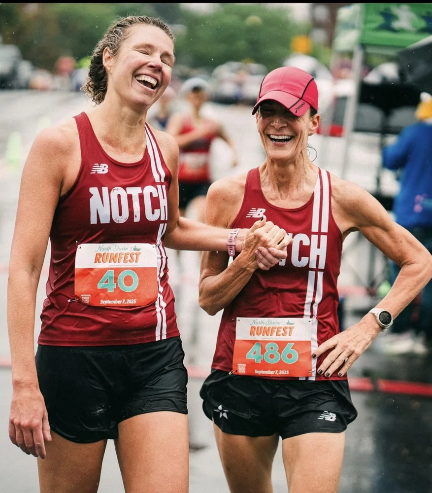 Two Notch teammates laughing together as they finish a race
