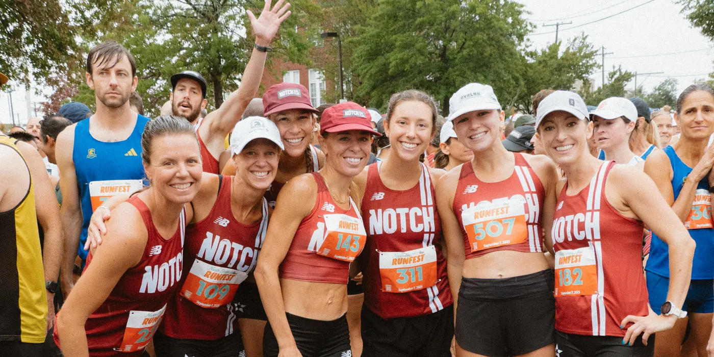 Notch teammates arm in arm at a race start line